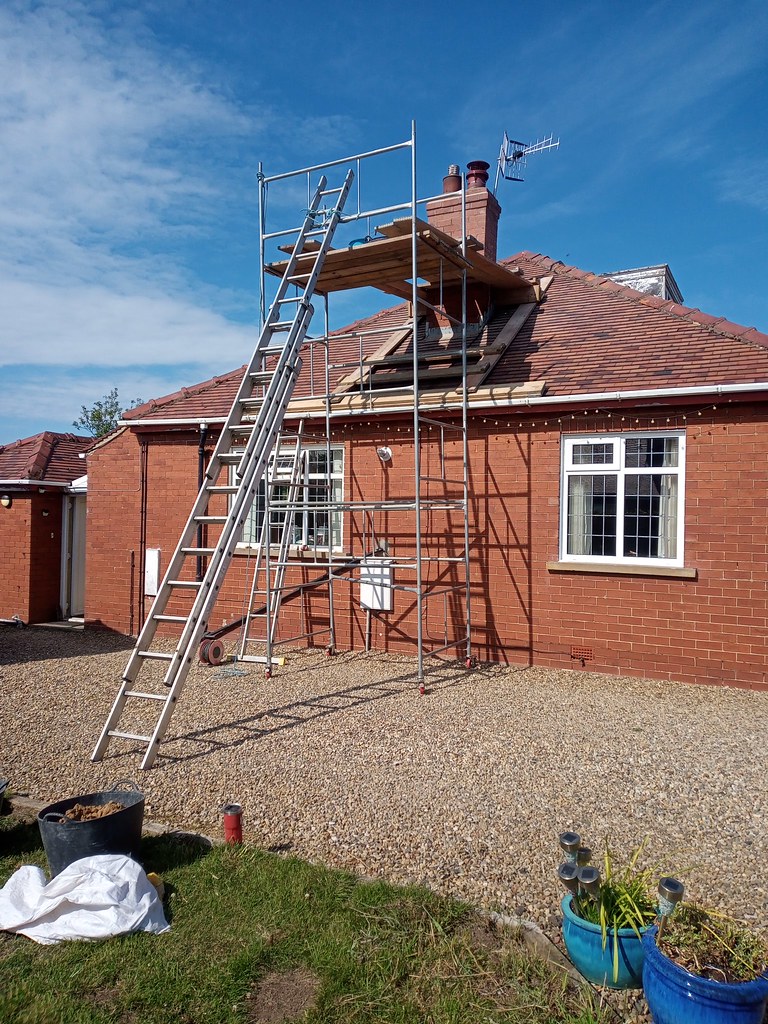 Scaffolding erected for roof and chimney repair work on a residential property by Greener Building