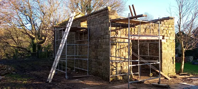 Stone building under construction with scaffolding in the North York Moors