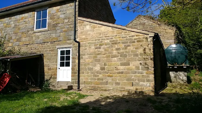 Renovated Yorkshire stone cottage exterior with new door and windows